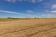 © Piotr - Extensive golden stubble fields after the harvest on a sunny day, with straw bales ready for collection, with a beautiful blue sky, ounty podkarpackie , Poland