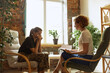 © master1305 - Sad young man in military uniform at therapy session with female psychiatrist, indoors. Concept of mental health, post-traumatic syndrome, help and support