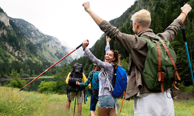 Wall Mural - hiking with friends is so fun. group of young people with backpacks together