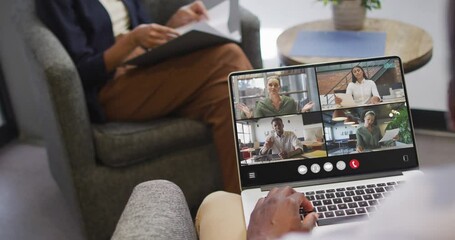 Sticker - African american man using laptop for video call, with diverse business colleagues on screen