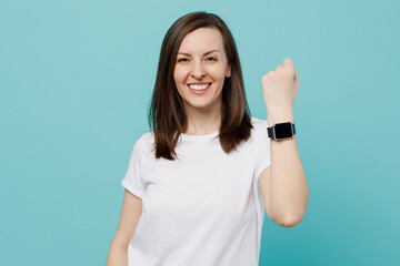 Young smiling fun caucasian woman 20s she wear white t-shirt smart watch with blank screen workspace area isolated on plain pastel light blue cyan background studio portrait. People lifestyle concept.