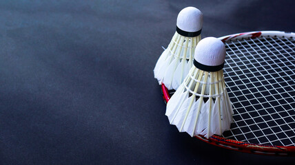 Badminton shutter cocks on racket are on dark background