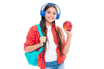 Back to school. Schoolgirl student in headphones with school bag backpack hold book on isolated studio background. School and education concept. Portrait of happy smiling teenage child girl.