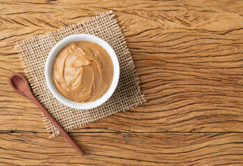 Doce de leite, traditional brazilian creamy milk sweet over wooden table with copy space