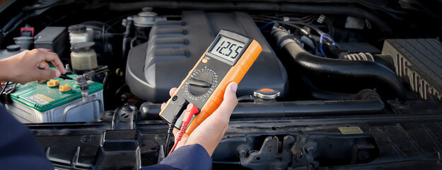 Wall Mural - Technicians inspect the car's electrical system.