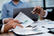 © kamiphotos - The sales department is having a monthly summary meeting to bring it to the department manager, they are verifying the correctness of the documents that are prepared before bringing in to the manager