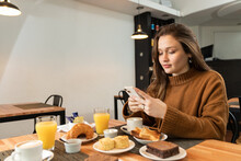 Female Using Smartphone During Breakfast In Cafeteria