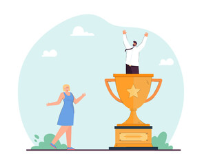 Wall Mural - female worker cheering for tiny businessman in huge gold cup. office people winning competition or g
