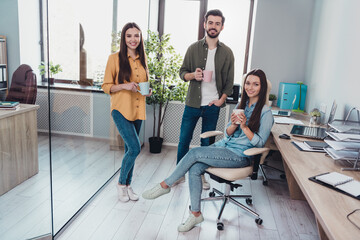 Poster - Portrait of three attractive cheerful people hr executive experts drinking latte free time at work place station indoors