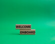 Welcome onboard symbol. Concept words Welcome onboard on wooden blocks. Beautiful green background. Business and Welcome onboard concept. Copy space.