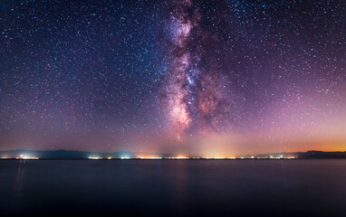 Wall Mural - Night landscape. Beautiful lake in the night under  starry sky with bright miky way galaxy.
