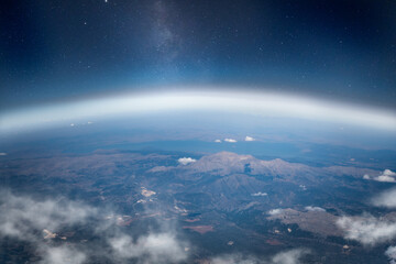 view of stars and milkyway above earth from space