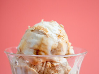 Caramel ice cream on a pink background.