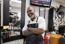 Portrait Happy, Smiling Barber With Tattoos And Arms Crossed