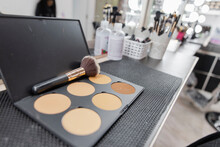 Bronzer Powder And Makeup Brush On Counter In Beauty Salon