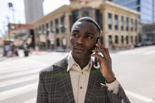 Stylish Young Businessman Talking On Smart Phone On City Street