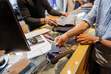 Close Up Man Paying With Smart Card At Clothing Store