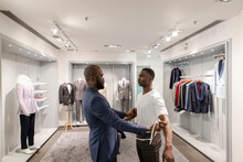 Tailor Fitting Customer For Suit In Menswear Shop