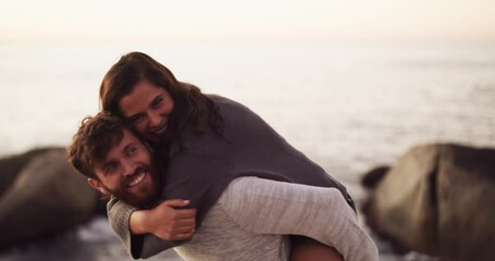 Canvas Print - Happy, love and young couple playful back ride, smile or laugh on the beach during sunset. Portrait of man and woman on summer vacation having fun and affection together with ocean in the background