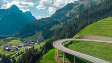 Beautiful austrian valley with village of Oberboden close to a nice road bridge with a hairpin turn on it with magnificent panorama of the mountains.
