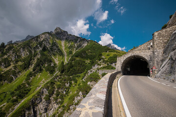 Flexenass road rising up from Lechtal in austria on a summer day. Crazy winding road from the valley up on the high alpine road.