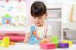 © M-image - young girl playing creative blocks at home