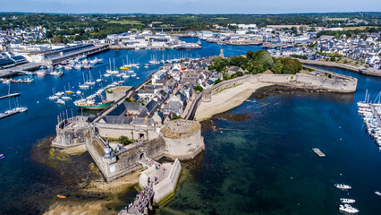 Wall Mural - Aerial view of Concarneau, a medieval walled city in Brittany, France - Clock tower in the corner of the fortified island accessed by a stone bridge along the coast of the Atlantic Ocean