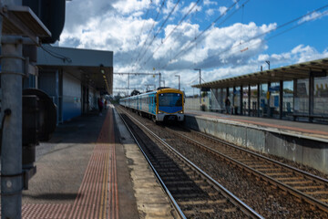 Commuter train approaching a train station in Melbourne Victoria Australia