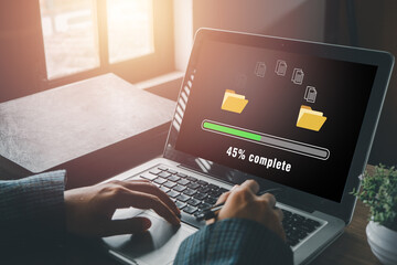 Transfer files data system relocation concept, Person hand using laptop computer waiting for transfer file process with loading bar icon on virtual screen.