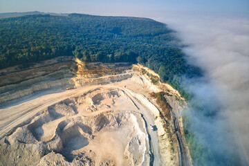 Wall Mural - Aerial view of open pit mining of limestone materials for construction industry with excavators and dump trucks