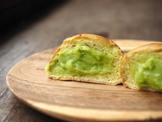 pandan custard cream bread bun on wooden plate