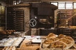 © Wavebreak Media - Loaf of bread and dough on tables with oven in background at bakery