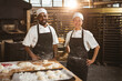 © Wavebreak Media - Portrait of smiling multiracial mid adult bakers standing in bakery