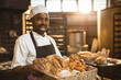 © Wavebreak Media - Portrait of african american mid adult male baker holding basket with fresh breads in bakery