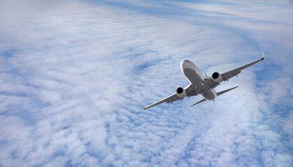 White passenger airplane flying in the sky amazing clouds in the background - Travel by air transport