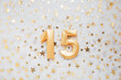 Number 15 fifteen golden celebration birthday candle on Festive Background. fifteen years birthday. concept of celebrating birthday, anniversary, important date, holiday