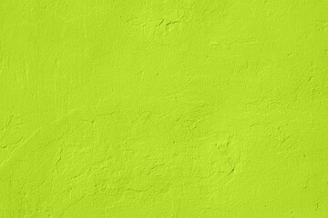 saturated light pastel lime green colored low contrast concrete textured background. empty colorful 