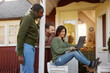 © Johnér - Group of friends with laptop in front of wooden house
