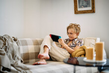 Boy On Sofa Using Digital Tablet