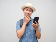 © Thanasak - Traveler man hold mobile phone thoughtful about booking at holiday isolated