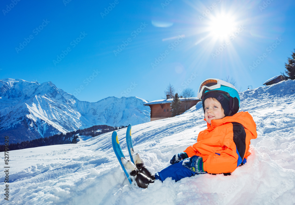 Smiling Boy with ski ready for skiing school sit in snow Stock Photo ...