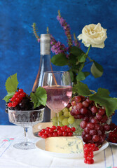 Poster - Grapes, wine and cheese on a table. Colorful summer still life on textured background with copy space.