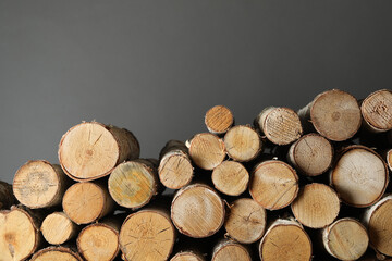 Wall Mural - Cut firewood on grey background. Heating in winter