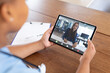 © vectorfusionart - Caucasian businesswoman writing on book during video call with african american female doctor