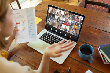 Poster - Asian businesswoman briefing report to colleagues during video conference through laptop in office