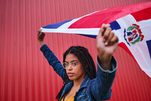 Ethnic Woman With Dominican Republic Flag On Red Background