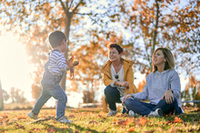 Lesbian Family With Son In Autumn Park
