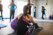 © ADDICTIVE STOCK - Woman doing exercises with fitness ball in rehabilitation center