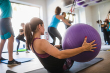 Woman Doing Exercises With Fitness Ball In Rehabilitation Center