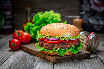 Wall Mural - Fresh tasty burger on wood table